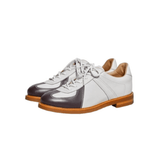 A pair of men's two-tone German army trainers with a cowhide upper, featuring white and coffee brown colors, a cushioned leather insole, and a grippy rubber outsole.