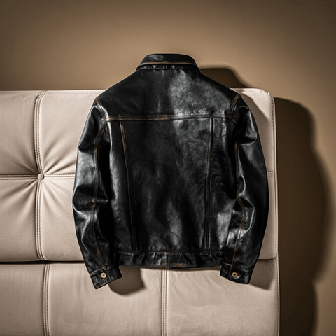 Black leather jacket on a beige sofa against a brown background