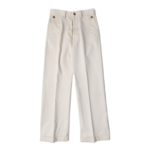 A pair of beige, high-waisted, wide leg chino pants with brass front fruit buckle closure.